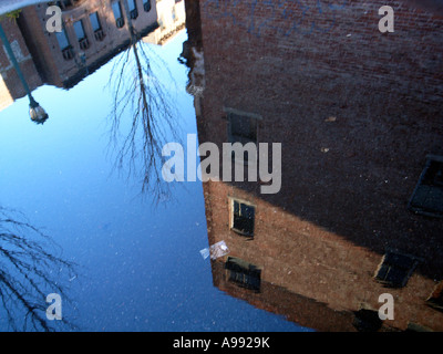 Buildings reflected in puddle after rain storm creates an urban abstract Stock Photo