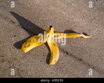 Banana peel on a sidewalk danger concept Stock Photo