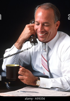 male business executive talking on phone during coffee break Stock Photo
