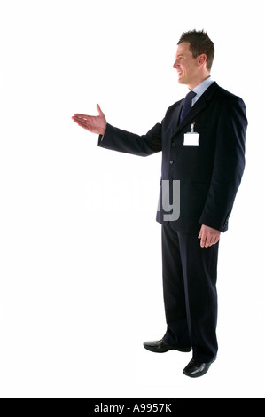 Businessman with his hand out making an introduction blank ID card Stock Photo