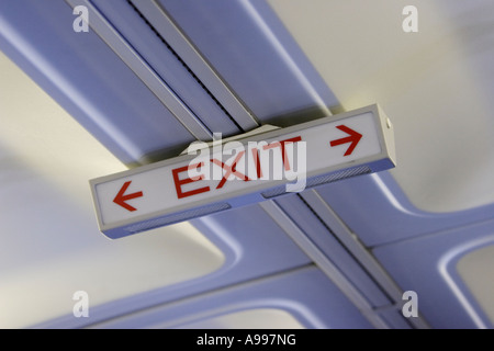 Exit sign on airplane Boeing 737 interior Stock Photo