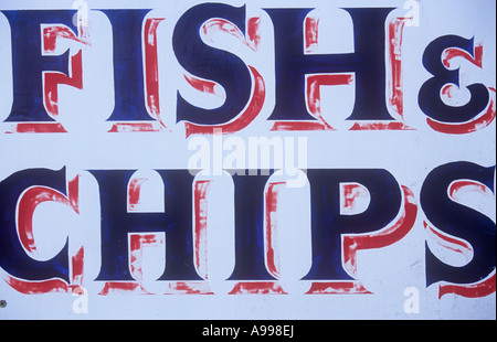 Close up of professional hand painted blue red and white sign beginning to fade stating Fish and Chips Stock Photo