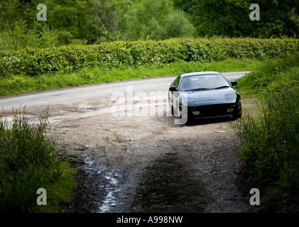 Toyota MR2 sportscar parked on gravel road Stock Photo