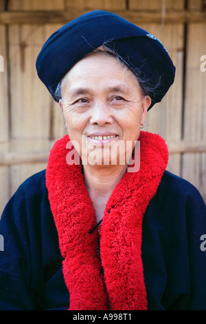 A Lu Mien woman also called Yao woman with colorful red pom pom neck scarf in northern Thailand. Stock Photo