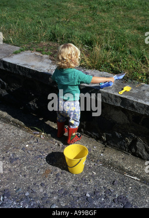 little-girl-digging-hole-in-garden-stock-photo-alamy