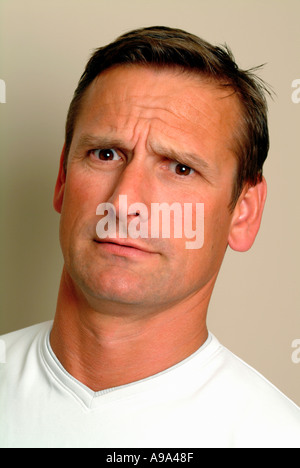 portrait of man in 30s looking confused Stock Photo