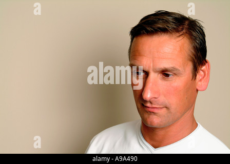 portrait of man in 30s looking down Stock Photo