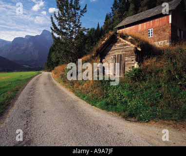 A country lane and rustic wooden buildings in the mountainous Fjaerland district Norway Stock Photo
