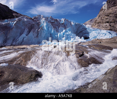 A vigourous melt water stream issuing from the snout of the Nigardsbreen glacier Jostedal National Park Norway Stock Photo