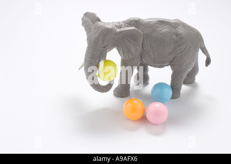 Elephant Figurine with String of Balls Stock Photo - Alamy