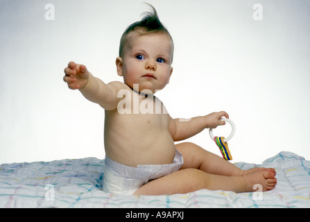 INFANT BABY PLAYING WITH COLORED TOY KEYS Stock Photo