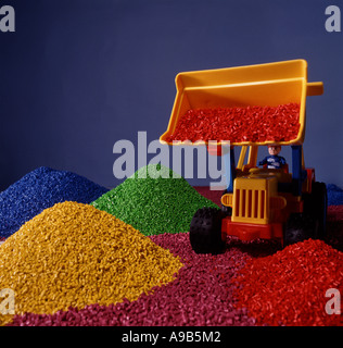 Toy plastic loader truck with piles of coloured plastic beads. Plastic microbeads concept. Stock Photo