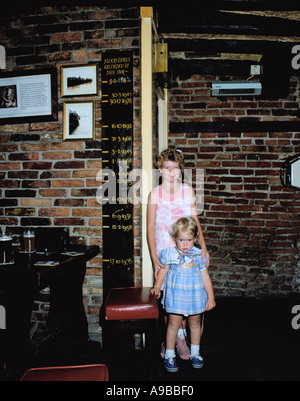 Children standing next to the flood level indicator in the King's Arms, Kings Staithe, City of York, North Yorkshire, England UK Stock Photo