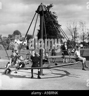 CHILDREN ON A ROUNDABOUT in 1943 - they were evacuated from London during the war Stock Photo