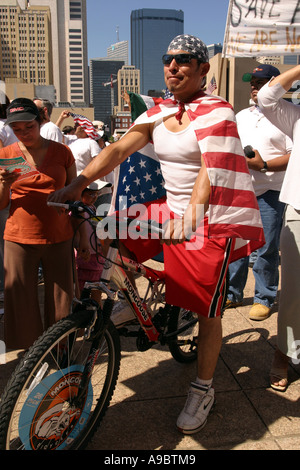 American Hispanic male on a bike, wearing American flag. Immigration rally, Dallas, Texas, USA Stock Photo
