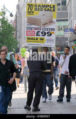 A man holding a sign advertising a sale, Oxford Street, London, UK. 2006. Stock Photo
