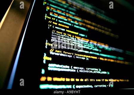 Highly technical looking computer program on screen in darkened room Stock Photo