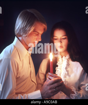 romantic young couple renewing vows by candlelight Stock Photo