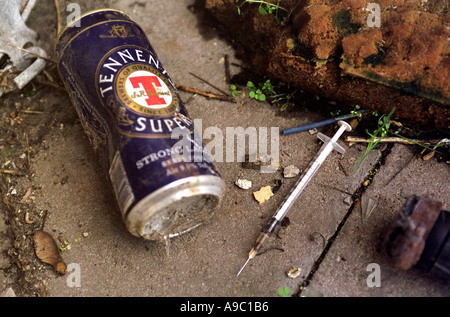 Needles used to inject illegal drugs thrown on ground after use. Stock Photo