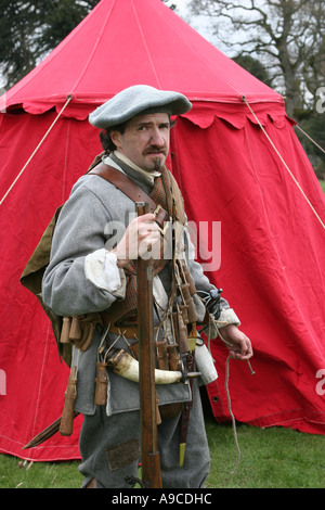 Armed Musketeer reenactor ressed in colourful historical period costume of The Sealed Knot Society, Scotland, UK, Stock Photo