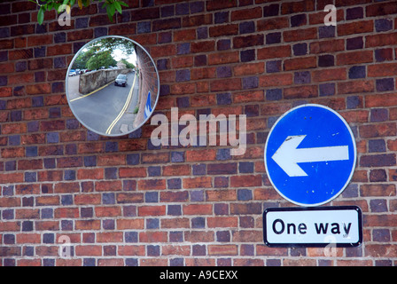 Convex mirror at difficult road exit, Castle Lane, Warwick, Warwickshire, England, UK Stock Photo