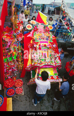 Villagers carrying Ceremonial Arch of Tinhau goddess in Tinhau festival Tapmun island Hong Kong china Stock Photo