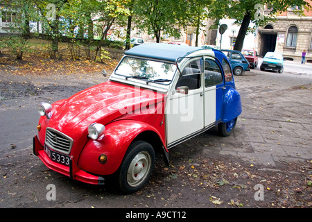 Beautiful red white and blue Citroen 2CV or French Deux Chevaux auto parked in courtyard. Lodz Poland Stock Photo