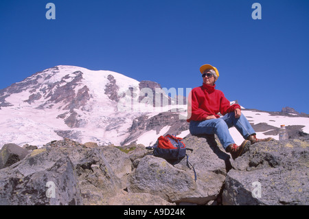 Mount Rainier National Park, Washington State, USA - Hiker taking a Break on Hiking Trail to Camp Muir below Nisqually Glacier Stock Photo