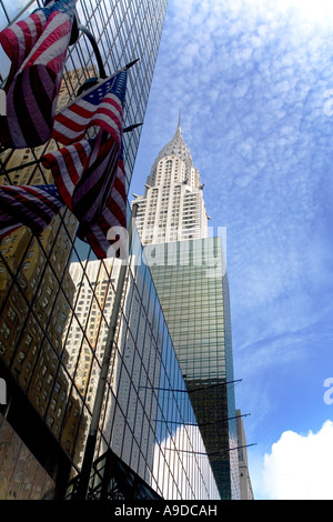 Chrysler Building and american stars and stripes flags with skyscapers in midtown Manhattan New York City NY USA Stock Photo