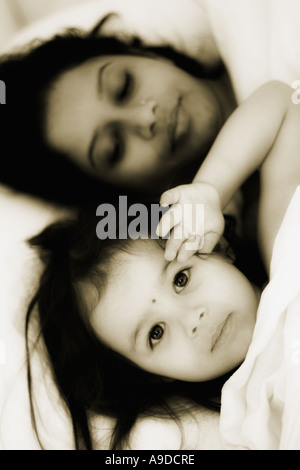 Mother and daughter in bed together Stock Photo