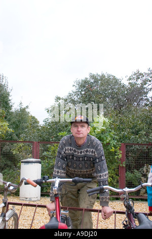 Young Polish man leaning on bicycle rack. Sadykierz Poland Stock Photo