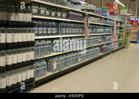Bottled mineral water on supermarket shelves Stock Photo