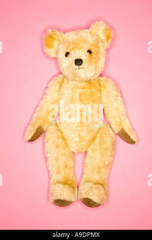 Traditional Teddy Bear flat lay on pink background Stock Photo