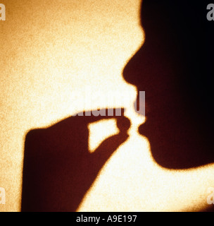 Woman African American taking pill medication medicine health medicate self holding Stock Photo