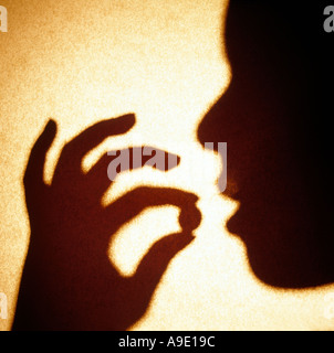 Woman African American taking pill medication medicine health medicate self holding Stock Photo