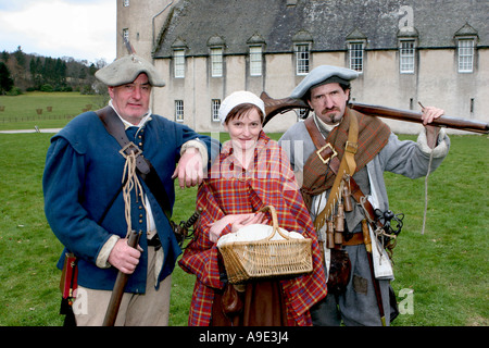 Group of three members men & women of  the Sealed Knot Society holding vintage musket, at re-enactment society gathering at Castle Fraser, Scotland Stock Photo