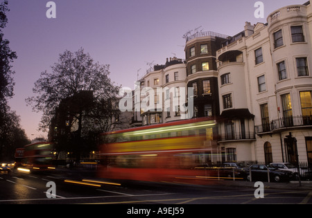 A double decker red London bus travels down Park Lane Stock Photo