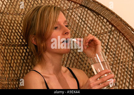 Young woman taking a tablet POSED BY MODEL Stock Photo