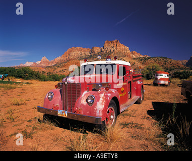 Old style red fire engine parked on scrubland at the entrance to Zion Canyon Utah USA Stock Photo