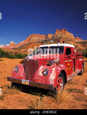 Old style red fire engine parked on scrubland at the entrance to Zion Canyon Utah USA Stock Photo