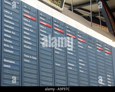 Cancelled red indicators on departure board  at Liverpool Street main line terminal railway station delays for evening rush hour commuters London UK Stock Photo