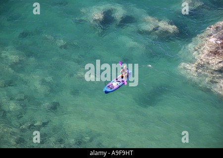 Canoeist in the clean and clear turquoise waters of Tasman Bay, Abel Tasman National Park, South Island, New Zealand Stock Photo