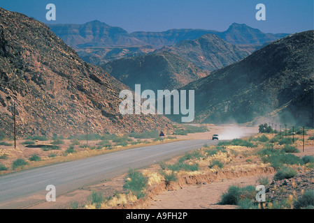 Car raising dust on the road from Fish River Canyon Park Namibia south west Africa Stock Photo