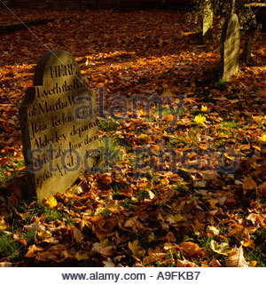 Prestbury Cheshire gravestone in autumnal churchyard Stock Photo