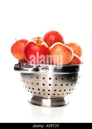 Selection Of Fresh Ripe Healthy Organic Red Apples In A Kitchen Colander Isolated Against A White Background With No People And A Clipping Path Stock Photo