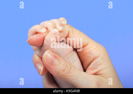 Baby and mother hand in hand Stock Photo