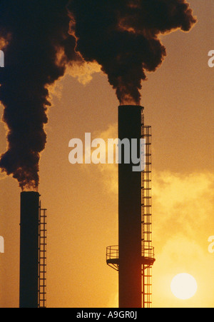 belching smokestacks global warming co2 emissions pollution at sunset Avonmouth England UK Stock Photo