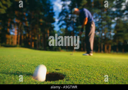golfer sinking a putt model released Surrey England UK Surrey England UK Stock Photo