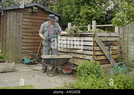Filling up the compost heap Stock Photo