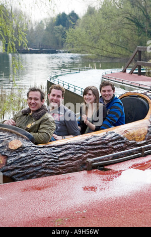 Group of young adults riding the Loggers Leap log flume ride at Thorpe Park Stock Photo